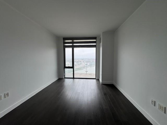 13105 40th Rd Unit 15E, Flushing, NY 11354 - empty room featuring dark wood finished floors and floor to ceiling windows