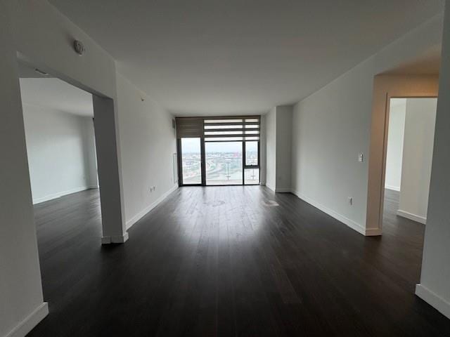 13105 40th Rd Unit 15E, Flushing, NY 11354 - empty room featuring dark wood-style floors and a wall of windows