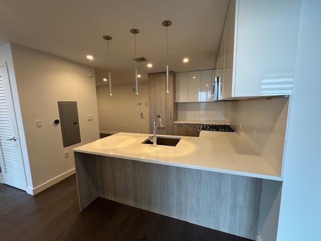 13105 40th Rd Unit 15E, Flushing, NY 11354 - kitchen with a peninsula, dark wood finished floors, modern cabinets, white cabinetry, and light countertops