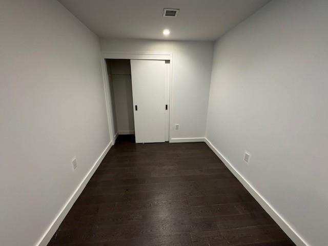 13105 40th Rd Unit 15E, Flushing, NY 11354 - unfurnished bedroom with dark wood finished floors and a closet