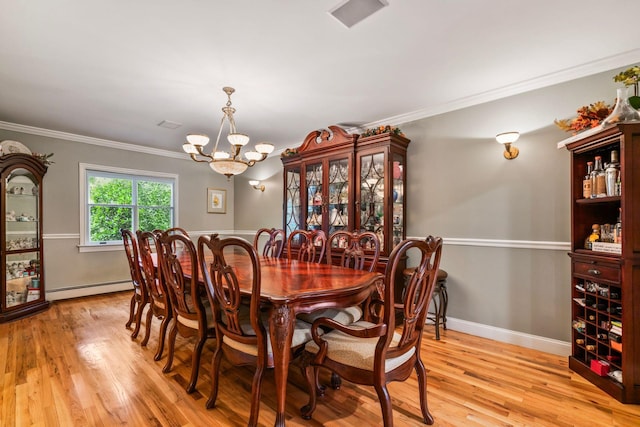 14 Etna Ln, Dix Hills, NY 11746 - dining area featuring a baseboard radiator, a chandelier, light wood-type flooring, and ornamental molding