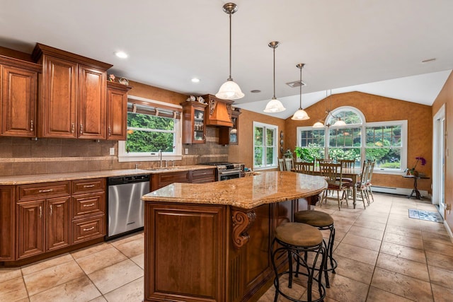 14 Etna Ln, Dix Hills, NY 11746 - kitchen featuring appliances with stainless steel finishes, healthy amount of natural light, a center island, a kitchen breakfast bar, and vaulted ceiling