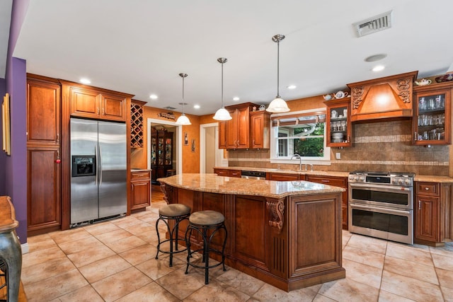 14 Etna Ln, Dix Hills, NY 11746 - kitchen with stainless steel appliances, tasteful backsplash, light stone countertops, a kitchen island, and glass insert cabinets
