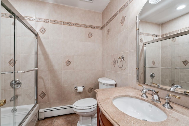 14 Etna Ln, Dix Hills, NY 11746 - bathroom with baseboard heating, tile walls, shower / bath combination with glass door, vanity, and tile patterned flooring