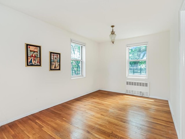679 W 239th St W Unit 3J, Bronx, NY 10463 - empty room with radiator heating unit, healthy amount of natural light, and light wood-style floors