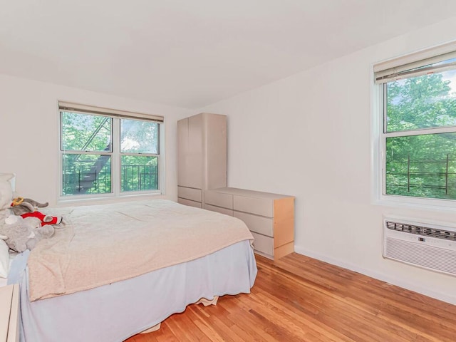 679 W 239th St W Unit 3J, Bronx, NY 10463 - bedroom with multiple windows, light wood-style floors, and a wall mounted air conditioner