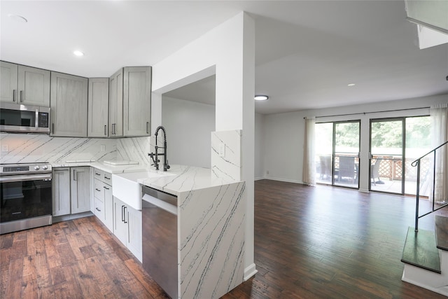 3103 Chelsea Cv S, Hopewell Junction, NY 12533 - kitchen with stainless steel appliances, gray cabinetry, light stone counters, tasteful backsplash, and open floor plan