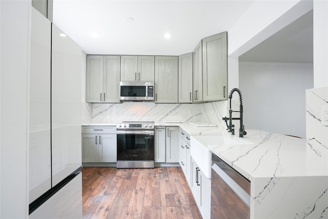 3103 Chelsea Cv S, Hopewell Junction, NY 12533 - kitchen with appliances with stainless steel finishes, gray cabinetry, light stone counters, dark wood-type flooring, and recessed lighting