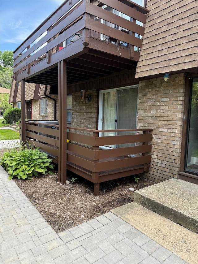 40 New Holland Vlg, Nanuet, NY 10954 - entrance to property featuring brick siding, a shingled roof, and a wooden deck