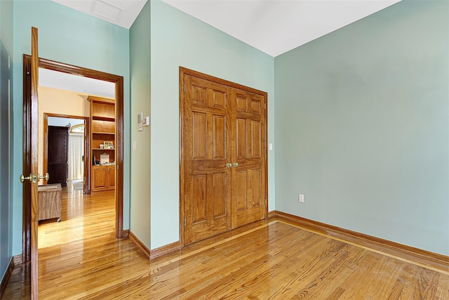 60-14 69th Pl, Maspeth, NY 11378 - unfurnished bedroom featuring light wood-style flooring and a closet