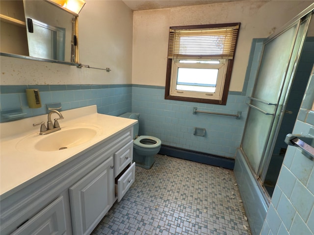 6 James Pl, Wappingers Falls, NY 12590 - full bathroom with tile walls, baseboard heating, vanity, a wainscoted wall, and tile patterned floors