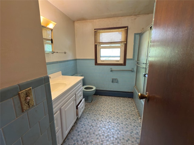 6 James Pl, Wappingers Falls, NY 12590 - full bathroom with tile walls, vanity, wainscoting, tile patterned floors, and a baseboard radiator