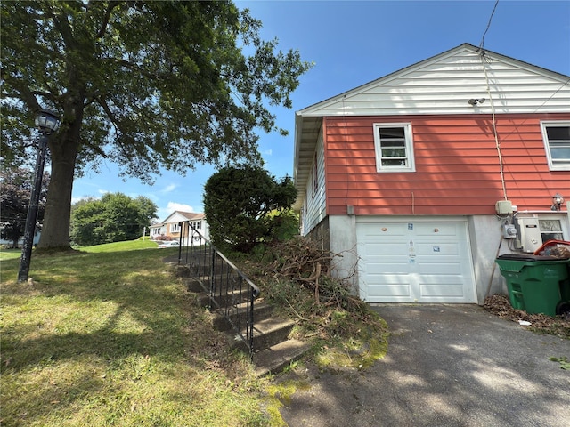 6 James Pl, Wappingers Falls, NY 12590 - view of side of home with driveway, an attached garage, and a lawn