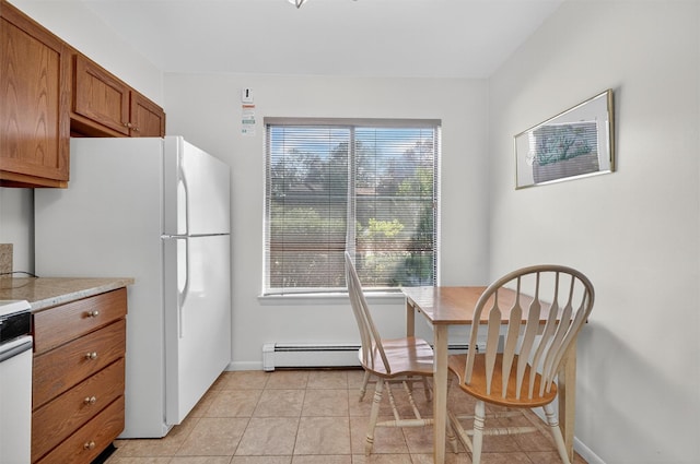 3 Adrian Ct Unit B, Cortlandt Manor, NY 10567 - kitchen featuring a baseboard heating unit, brown cabinets, freestanding refrigerator, light countertops, and light tile patterned floors