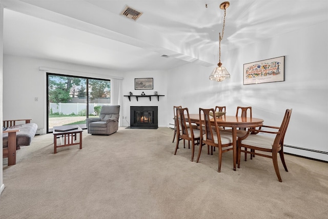 3 Adrian Ct Unit B, Cortlandt Manor, NY 10567 - dining area featuring a glass covered fireplace, light carpet, and baseboard heating