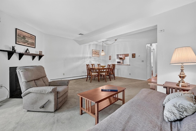3 Adrian Ct Unit B, Cortlandt Manor, NY 10567 - living room featuring baseboard heating, carpet, a fireplace, and a chandelier