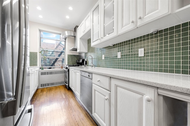 110-34 73rd Rd Unit 5A, Forest Hills, NY 11375 - kitchen with radiator, stainless steel appliances, white cabinetry, light wood-style flooring, and recessed lighting