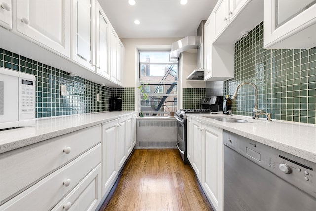 110-34 73rd Rd Unit 5A, Forest Hills, NY 11375 - kitchen featuring gas range, dishwashing machine, radiator heating unit, white microwave, and tasteful backsplash