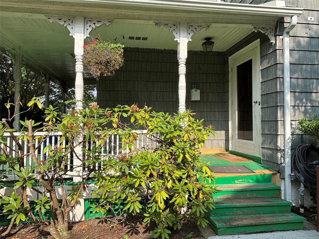 92 Walnut St, Lynbrook, NY 11563 - property entrance with a porch