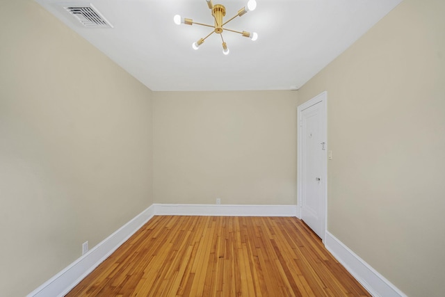 52 Mc Cue Ln, Babylon, NY 11702 - empty room with a chandelier and light wood-style floors