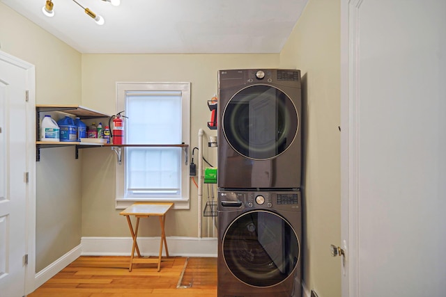 52 Mc Cue Ln, Babylon, NY 11702 - laundry room with stacked washer / dryer and wood finished floors