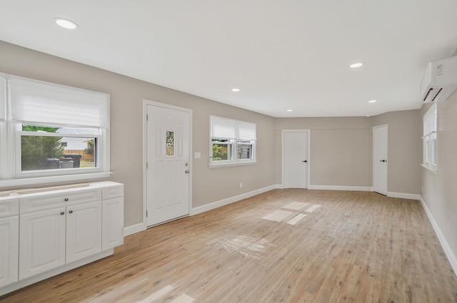 52 Mc Cue Ln, Babylon, NY 11702 - foyer entrance with a wall mounted AC, light wood-type flooring, and recessed lighting