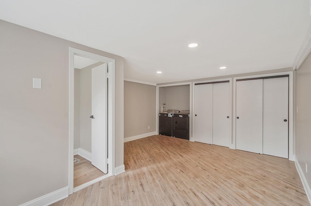 52 Mc Cue Ln, Babylon, NY 11702 - unfurnished bedroom with light wood-type flooring, two closets, washing machine and clothes dryer, and recessed lighting