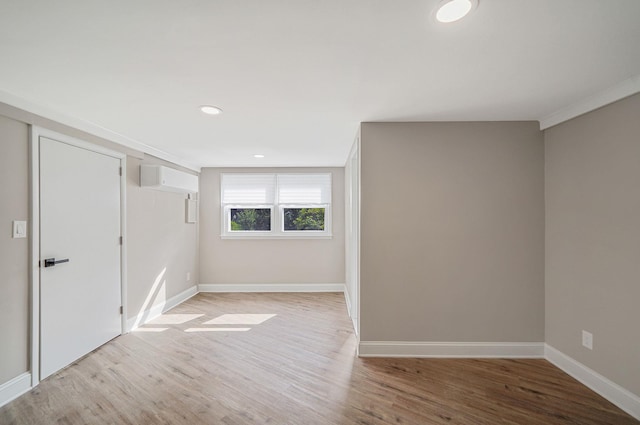 52 Mc Cue Ln, Babylon, NY 11702 - unfurnished bedroom featuring light wood-style flooring, recessed lighting, and a wall unit AC