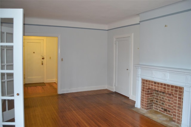 292 Main St Unit 4C, White Plains, NY 10601 - unfurnished living room featuring hardwood / wood-style flooring, a tiled fireplace, and crown molding