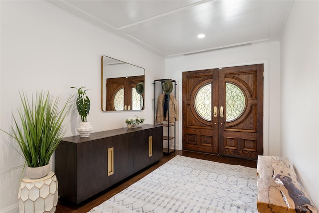 130 Carthage Rd, Scarsdale, NY 10583 - foyer entrance with healthy amount of natural light, dark wood-type flooring, crown molding, and french doors