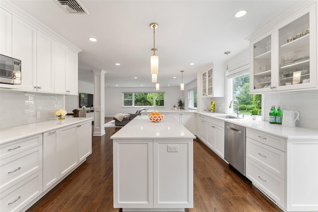 130 Carthage Rd, Scarsdale, NY 10583 - kitchen with appliances with stainless steel finishes, ornate columns, backsplash, healthy amount of natural light, and recessed lighting