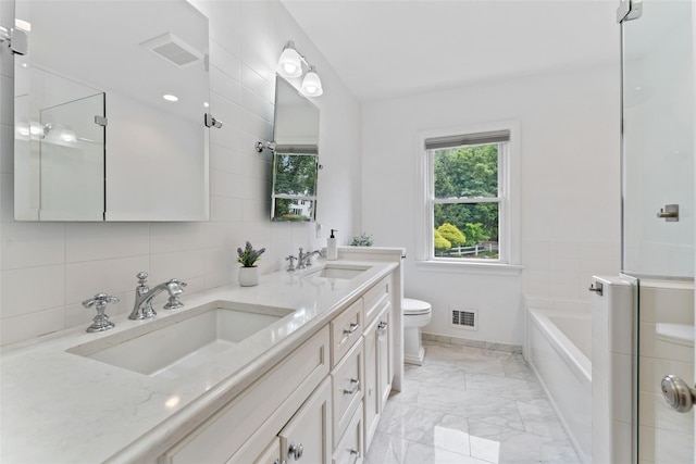 130 Carthage Rd, Scarsdale, NY 10583 - bathroom with double vanity, a garden tub, marble look tile flooring, and tile walls