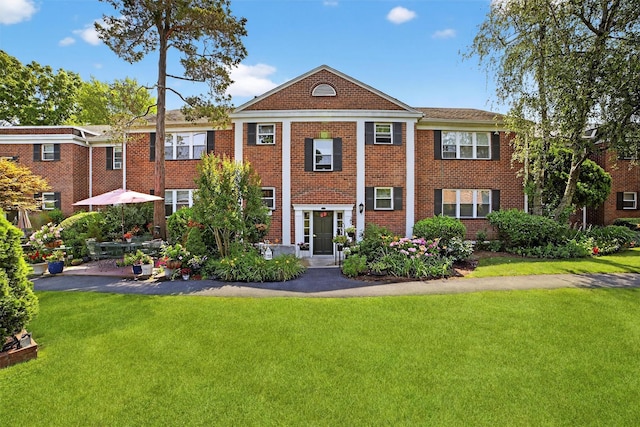 135 S Highland Ave Unit B5, Ossining, NY 10562 - neoclassical home with a front lawn and brick siding