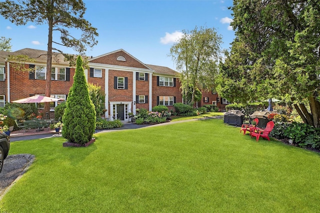 135 S Highland Ave Unit B5, Ossining, NY 10562 - view of front of house with brick siding and a front lawn