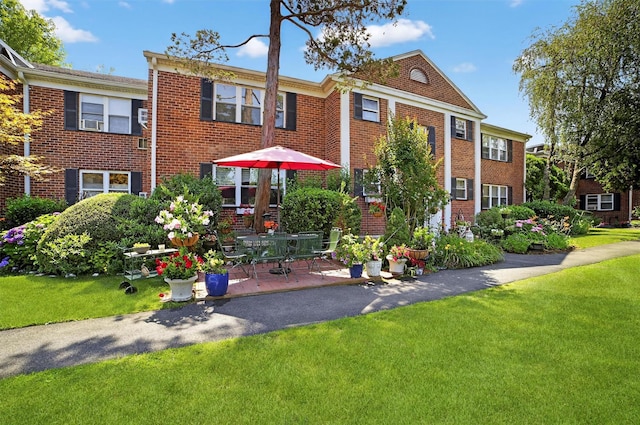 135 S Highland Ave Unit B5, Ossining, NY 10562 - view of front of property with a front lawn, brick siding, and a patio area