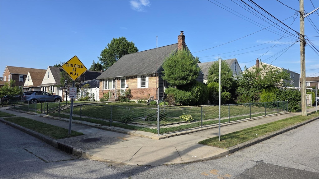311 Travis Ave, Elmont, NY 11003 - view of front of home featuring brick siding and a chimney