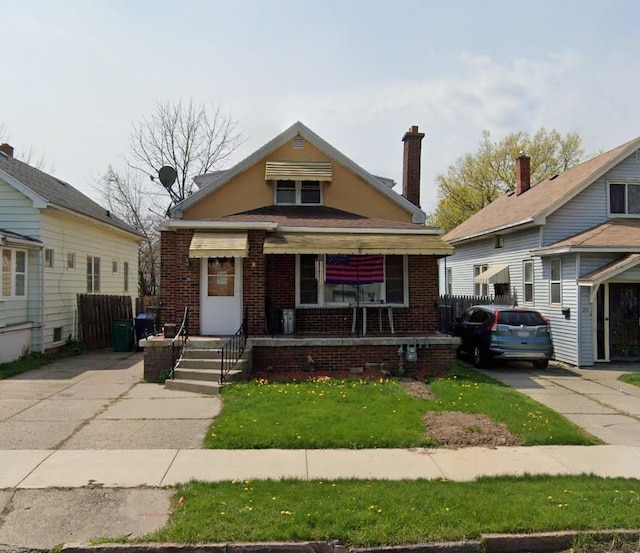 26 Eggert Rd, Call Listing Agent, NY 14215 - bungalow-style house with brick siding, a porch, and a front yard
