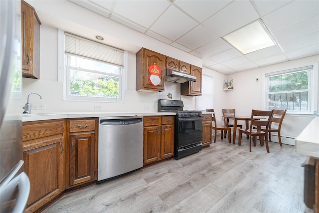 58-44 219th St, Bayside, NY 11364 - kitchen featuring dishwasher, black range with gas cooktop, under cabinet range hood, light wood-style flooring, and light countertops