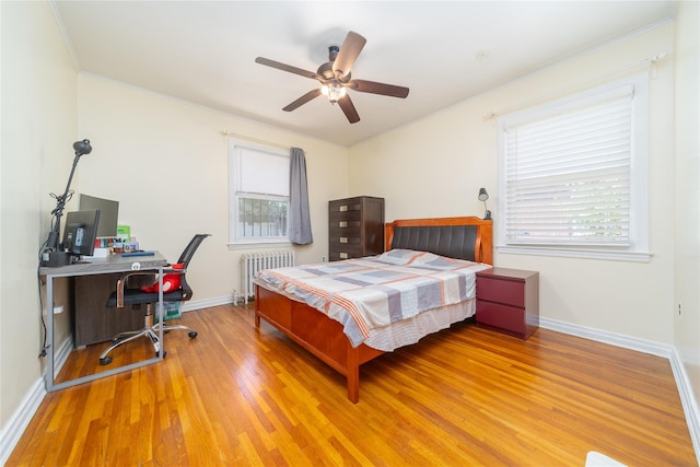 58-44 219th St, Bayside, NY 11364 - bedroom with radiator, wood finished floors, crown molding, a desk, and ceiling fan