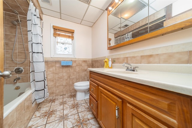 58-44 219th St, Bayside, NY 11364 - bathroom with tile walls, vanity, tiled shower / bath, tile patterned flooring, and a wainscoted wall