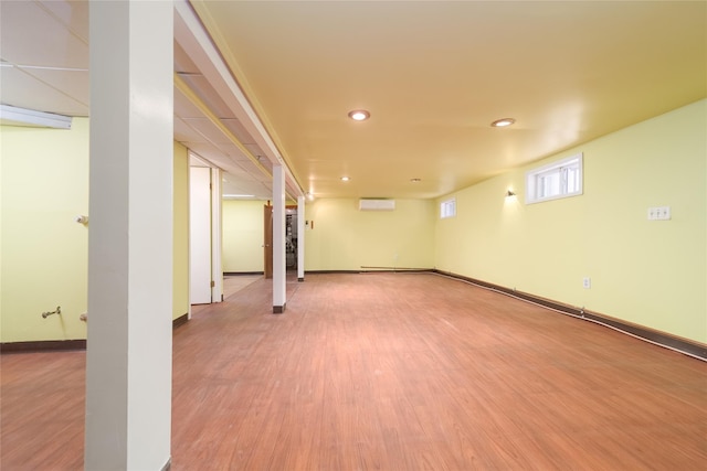 58-44 219th St, Bayside, NY 11364 - below grade area featuring a wall unit AC, wood finished floors, and recessed lighting