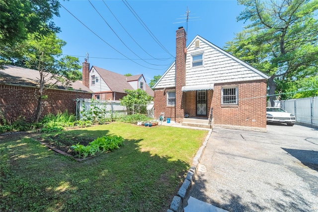 58-44 219th St, Bayside, NY 11364 - back of property featuring brick siding and a chimney