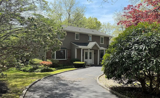 8 Lisa Dr, Dix Hills, NY 11746 - view of front of home featuring asphalt driveway, brick siding, and a front yard