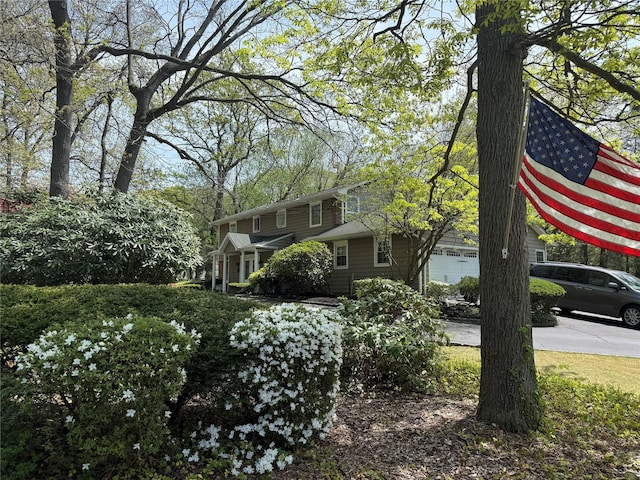8 Lisa Dr, Dix Hills, NY 11746 - view of yard featuring concrete driveway and a garage