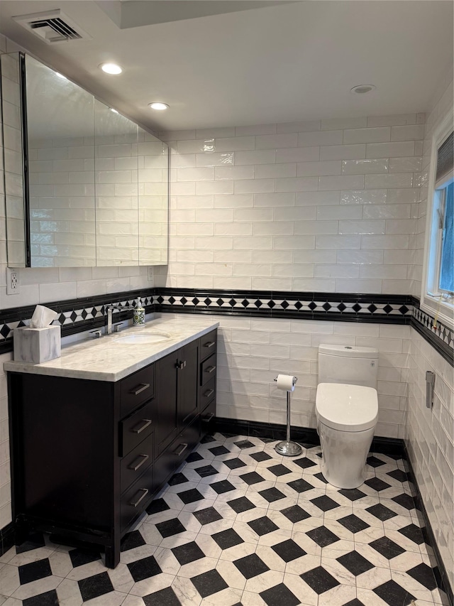 8 Lisa Dr, Dix Hills, NY 11746 - bathroom featuring vanity, tile walls, recessed lighting, and tile patterned floors