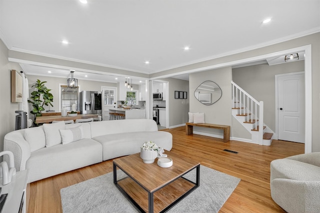 130 Cresthill Rd, Yonkers, NY 10710 - living area with stairs, light wood-style flooring, recessed lighting, and crown molding