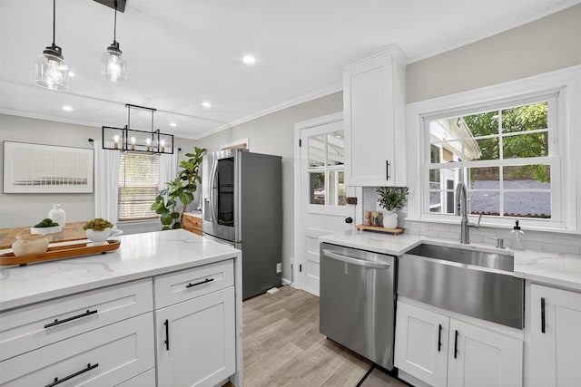 130 Cresthill Rd, Yonkers, NY 10710 - kitchen with stainless steel appliances, decorative backsplash, crown molding, plenty of natural light, and hanging light fixtures