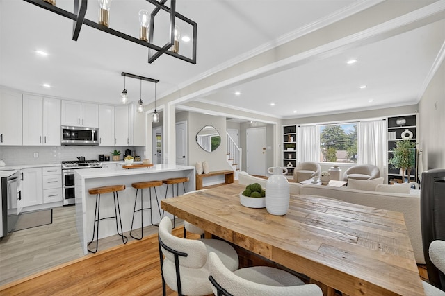 130 Cresthill Rd, Yonkers, NY 10710 - dining area with light wood-type flooring, ornamental molding, recessed lighting, and stairs