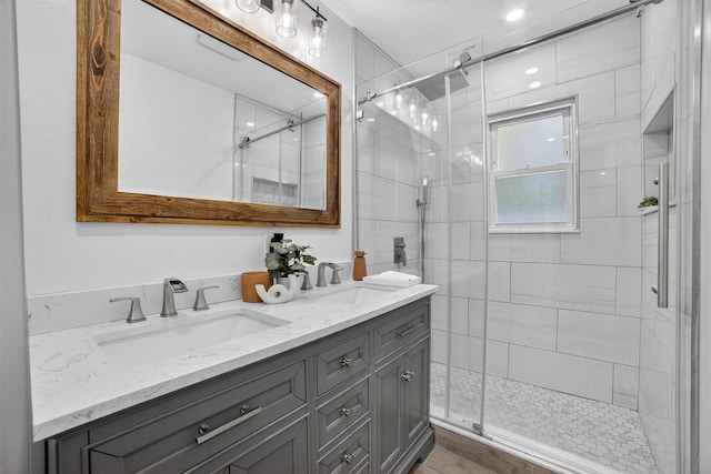 130 Cresthill Rd, Yonkers, NY 10710 - bathroom featuring double vanity, a stall shower, and wood finished floors