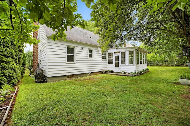 130 Cresthill Rd, Yonkers, NY 10710 - back of property featuring a sunroom, a yard, and roof with shingles